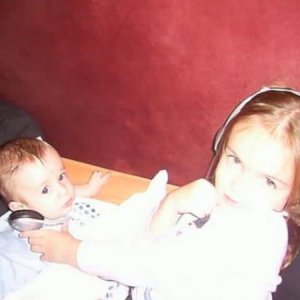 Playing some music for her baby brother