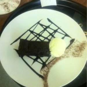 Chocolate fudge brownie with vanilla ice cream and chocolate sauce.