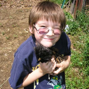 My 9 yr old at grandpa's house with his favorite chicken.