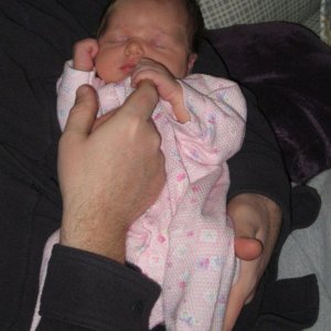 Holding daddy's finger.