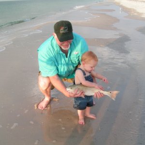 This is the first time my Grand Son had seen a fish. I had just caught it surf fishing at Gulf Shores.