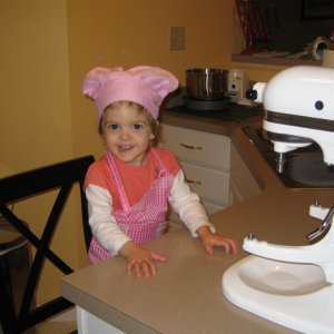 I found this adorable apron and hat at the dollar store, of all places!  Sofie had a blast wearing it and helping to make the cake and icing for her b
