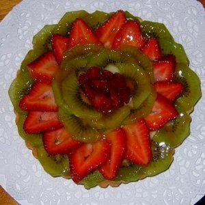 Fruit tart with fresh fruit (not ever frozen) vanilla pastry cream with a basic sweet pastry dough crust.