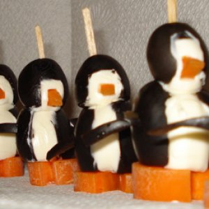Penguins made from olives, all in a row.