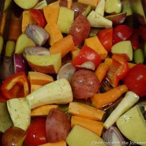 Chopped Potatoes, peppers, parsnips, carrots, sweet potatoes and garlic ready for oven