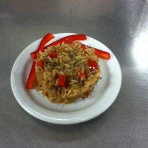 This is rice pilaf I made with my best friend. It has red bell pepper and onion in it. It was tasty. :)