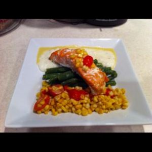 Cheese grits, corn, a sweet corn sauce and grilled salmon