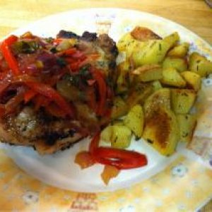 Broiled pork chop w/sweet n sour peppers and herb roasted potatoes.