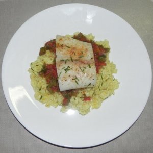 Baked cod served on tomato curry rice
