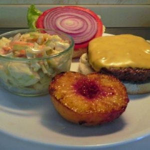 Hamburger with red onion and grilled peach and home made coleslaw