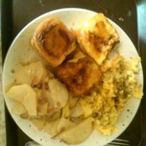 Hawaiin roll french toast, scrambled eggs w/ american and swiss cheese and potatoes