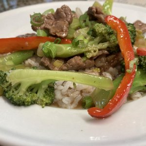 My version of Beef Broccoli served over Steamed White Rice.  I like to add Sweet White Onions and Sweet Bell Pepper.