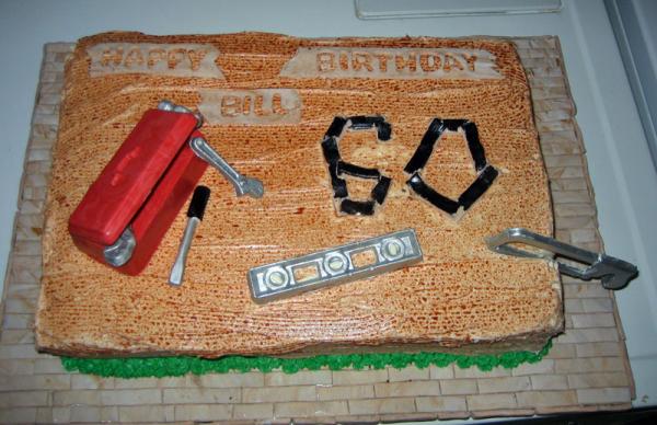 A 60th birthday cake for a hobby carpenter.  The "hardwood floor" detail on the cake board was a thank you for him helping us with our floors.  The to