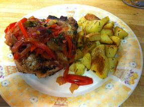 Broiled pork chop w/sweet n sour peppers and herb roasted potatoes.