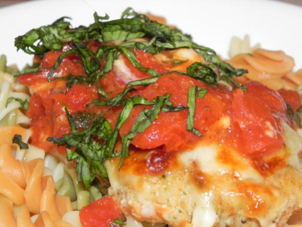 Chicken Parmesan on colorful noodles