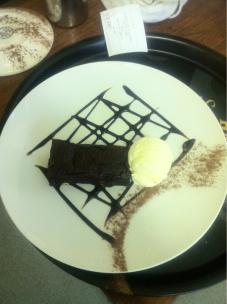 Chocolate fudge brownie with vanilla ice cream and chocolate sauce.