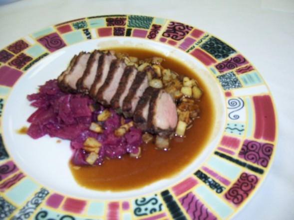 Duck breast with 3 potato hash and braised cabbage