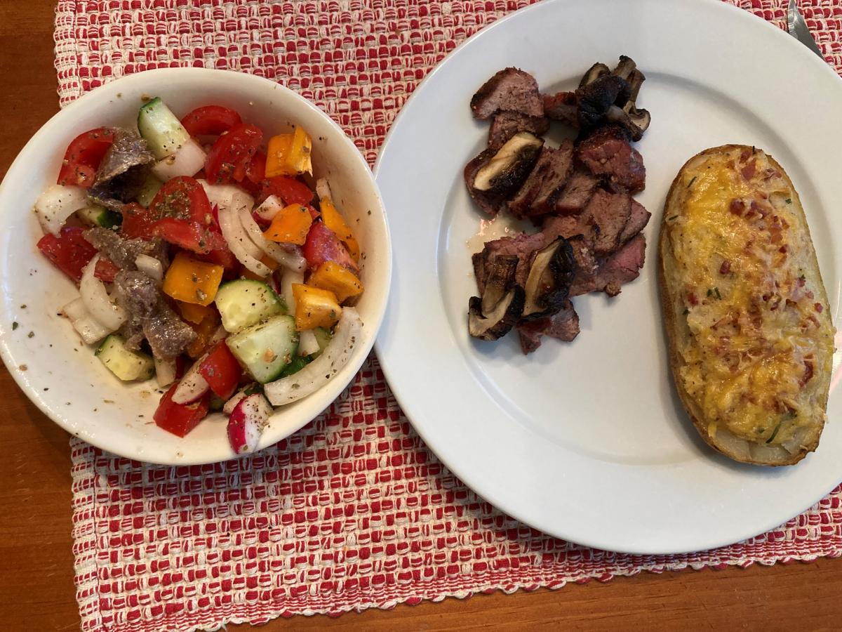 Grilled NY Strip Steak, topped with grilled Mushrooms, a Twice Baked Potato and a Chopped Salad, MMM!