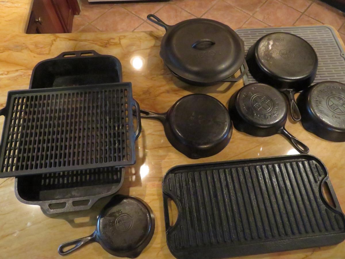 Griswold and Lodge cast iron: pots, two sided griddle, roasting pan and perforated grilling tray.