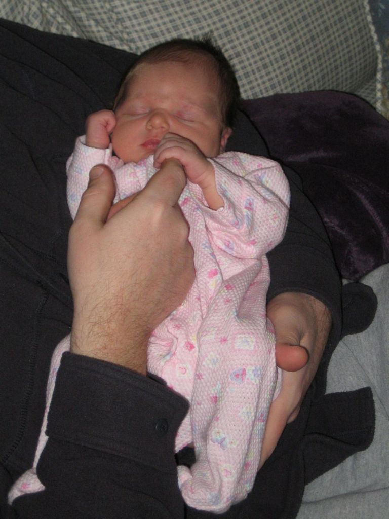 Holding daddy's finger.