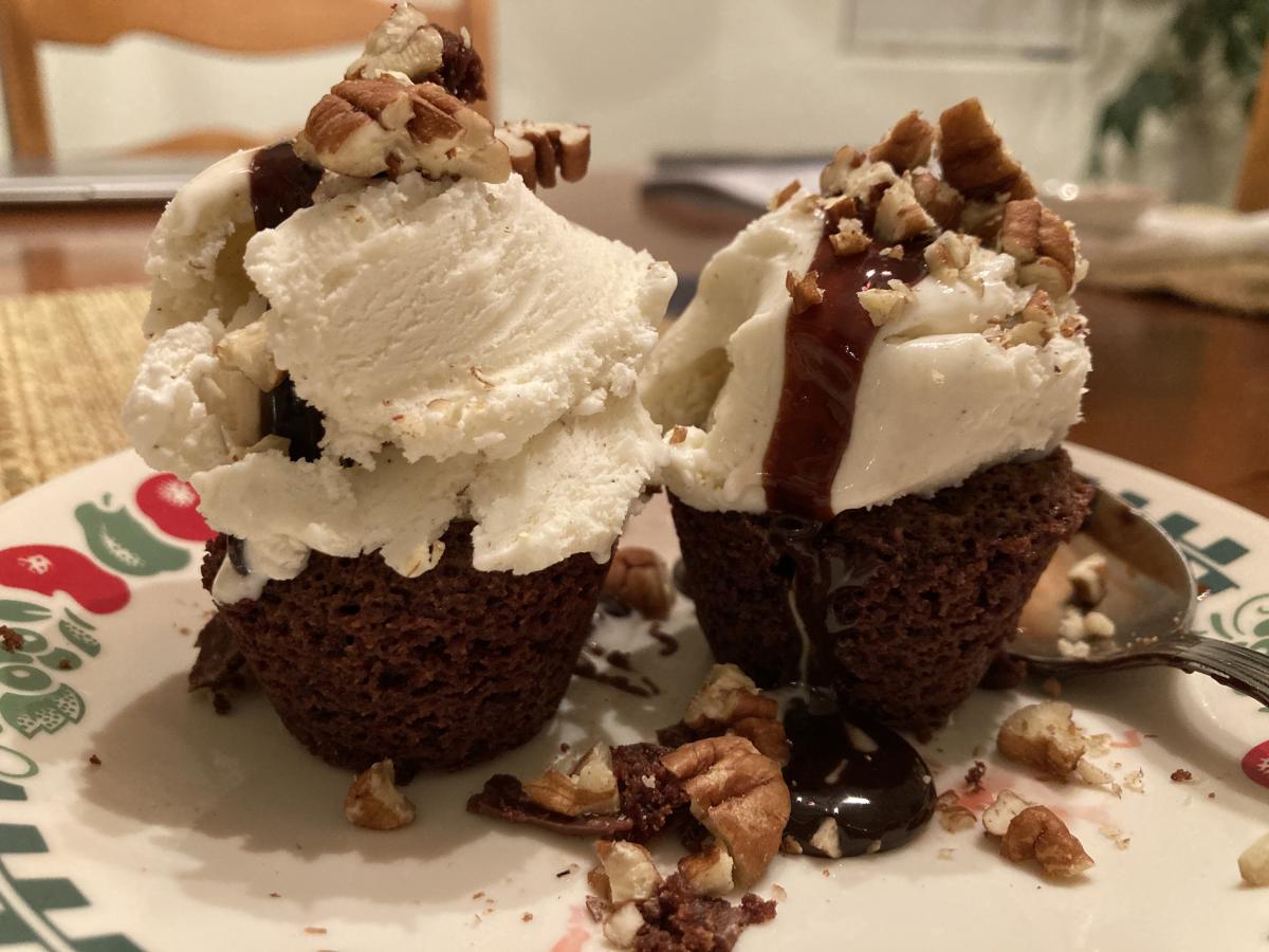 Homemade Brownie Bite, topped with a small disher of Tillamook Vanilla Ice Cream, Hot Fudge and chopped Pecans.