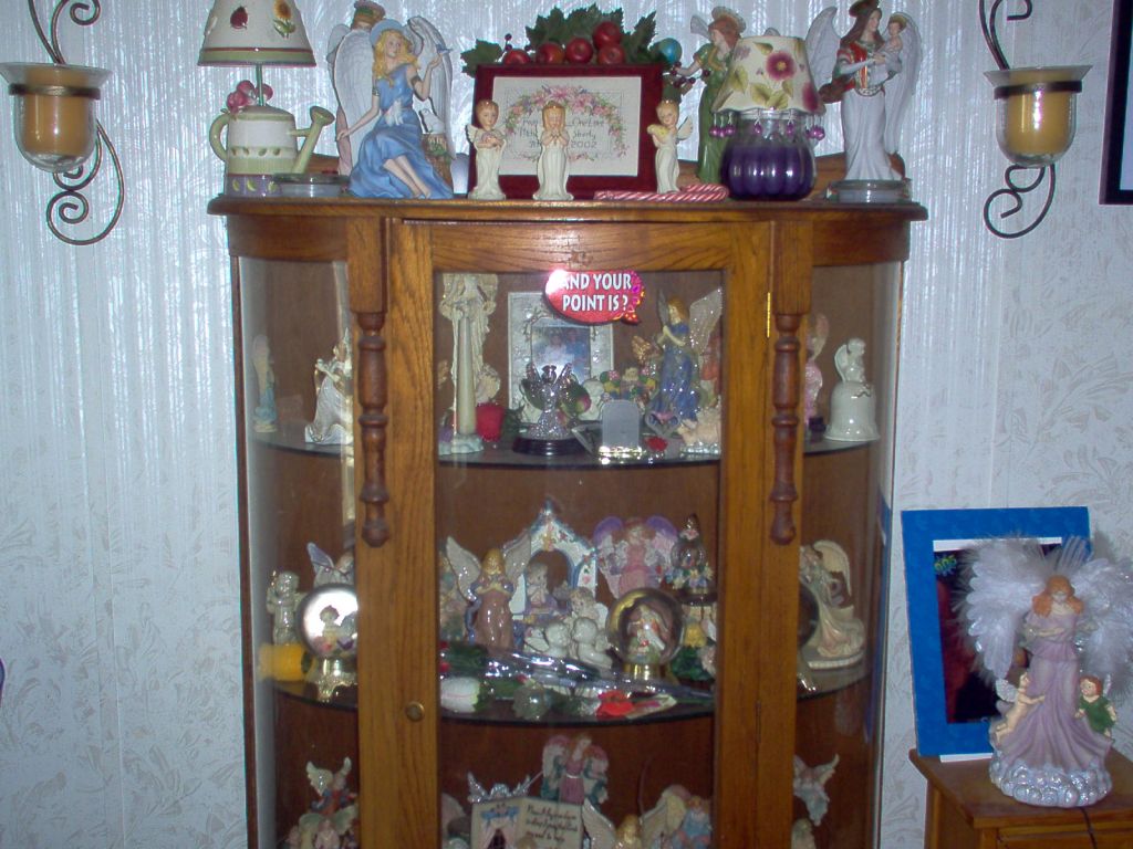 I collect angels and here is my most prize possesion one of my cabinets of angels
