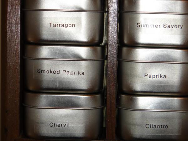 I purchased small 4-ounce food-grade containers at 64 cents a piece.  Each holds a two-ounce sized jar of dried herbs.  Frank used clear labels with b