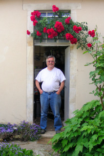 I'm standing outside my quite old French kitchen in Lignieres, FR.  Tomette floor, horsehair and lime walls and an open ceiling of limbs from local tr