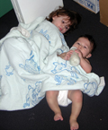 Our 2 lil' chefs sharing on of their mom's baby blankets