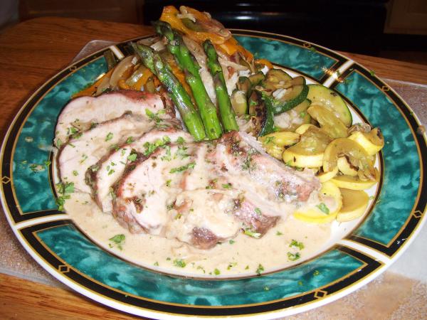 Pork Served With Apple Butter Cream Sauce And Summer Vegetables