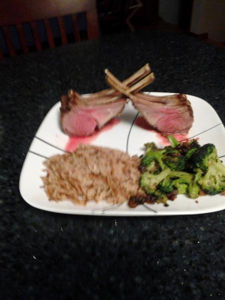 Rack of Lamb with herb crust, rice pilaf and broccoli sautéed with shallots and mushrooms.