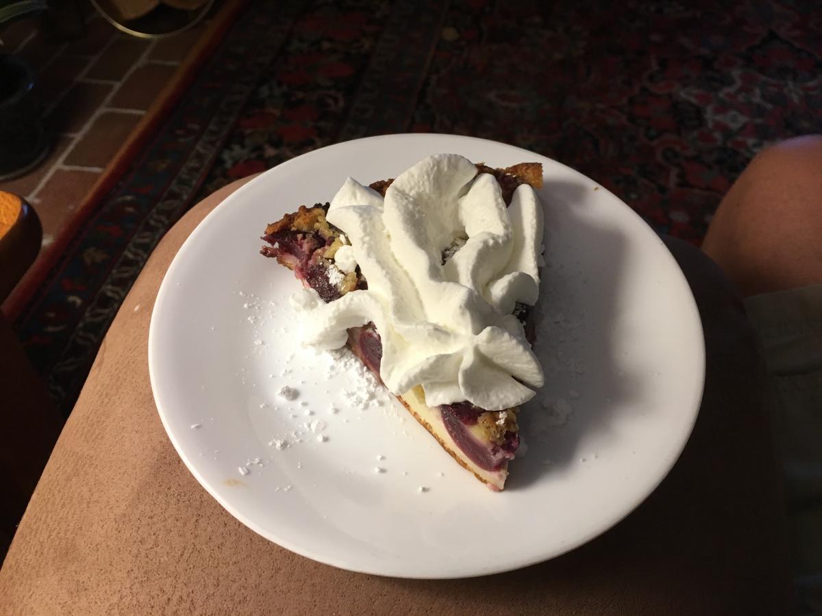 Slice of Cherry Clafoutis with Whipped Cream