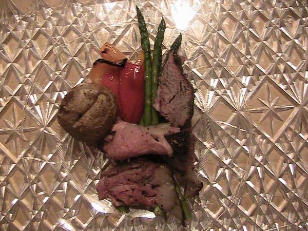 smoked prime rib with roasted asparagus and peppers. with a baked potato