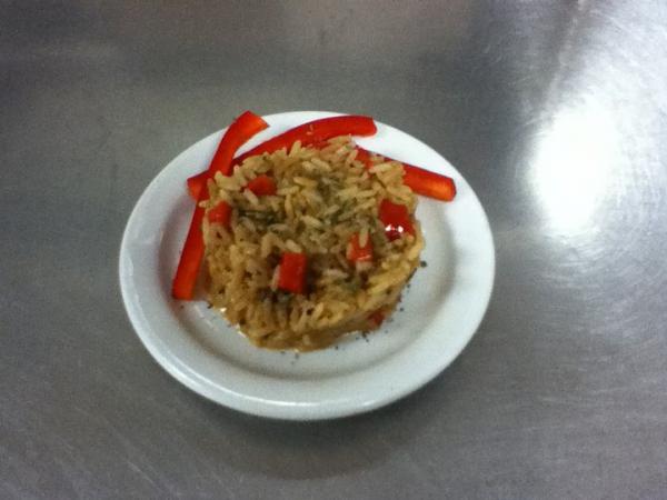 This is rice pilaf I made with my best friend. It has red bell pepper and onion in it. It was tasty. :)