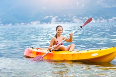 girl-enjoying-paddling-kayak-sea-water-summer-vacation-75676220.jpg