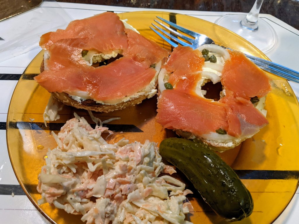 bagel with cream cheese and salmon, etc and coleslaw and a pickle.jpg
