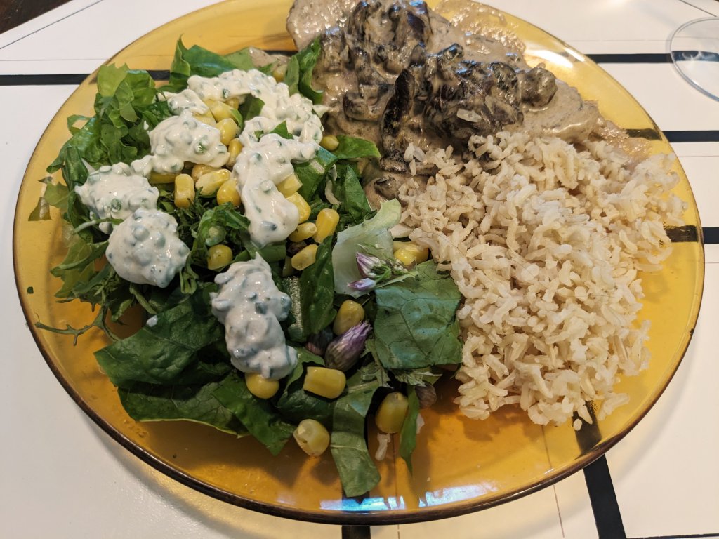 Pork chop in mushroom and herb sauce with brown basmati rice and a salad with crème fraiche an...jpg