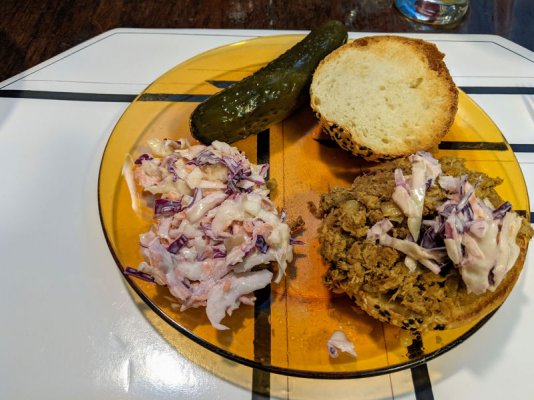 Pulled pork on a bun, coleslaw, and a pickle.jpg