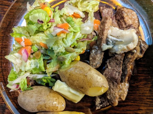 Striploin in cream sauce, garnished with blue cheese, fingerling potatoes, and salad.jpg