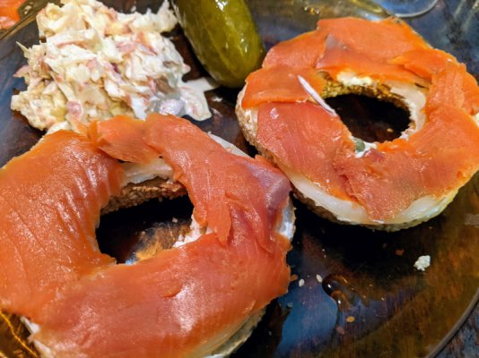 Smoked salmon on bagels with cream cheese, onion, and capers. Sides of dill pickles and coleslaw.jpg