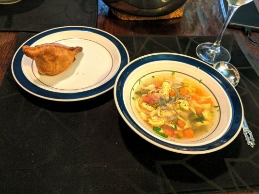 Homemade chicken soup and a store bought samosa.jpg