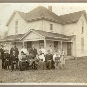 this is a photograph of my grandmother with all her 9 brothers and sisters, and their parents, in front of the house where all 10 children were raised