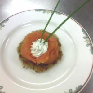 Smoked salmon with dill and chive sour cream on a potato latke.
