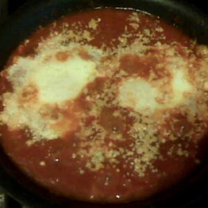 These are not two blobs of stuff floating in sauce - it's Eggs in Purgatory.  A favorite dish of mine, I usually have it when BF is away because he's 