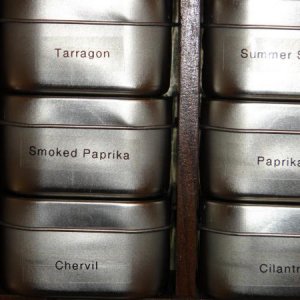 I purchased small 4-ounce food-grade containers at 64 cents a piece.  Each holds a two-ounce sized jar of dried herbs.  Frank used clear labels with b