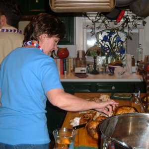 A friend picking at the chickens on the counter