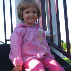 I figured I'd better post a new picture of Sofie.  She loves hanging out at the top of the tall slide at the park.  She says, "I like to sit here and 