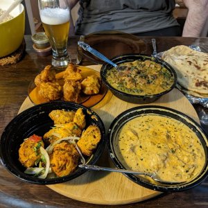 Supper delivered from Sahib, a local Indian resto.

Clockwise on the lazy Susan, starting at the top left: onion bhajis, methi gosht (lamb), chicken k