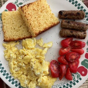 Leftover Sweet Cornbread from the night before, toasted, buttered and served with Eggs Sausage and diced Tomatoes.