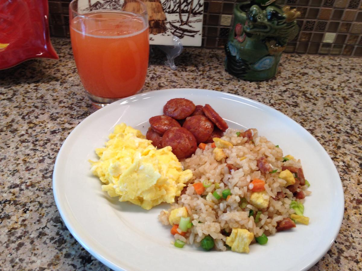 A classic breakfast, Portuguese Sausage or Linguica, Fried Rice, scrambled Eggs and a glass of POG or Passion-Orange-Guava juice